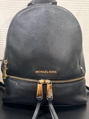 Michael Kors Rhea 
Black Pebbled Leather 
Mini Backpack with Gold Hardware